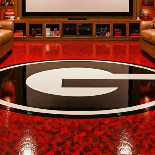 Man Cave Remodel featuring a sleek entertainment setup with leather seating and a bold red and black sports-themed floor d...