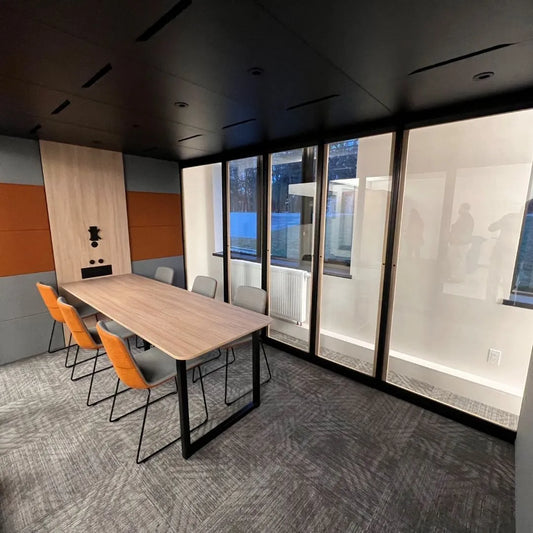 Modern home office remodel with sleek conference table, ergonomic chairs, and floor-to-ceiling windows for natural light.